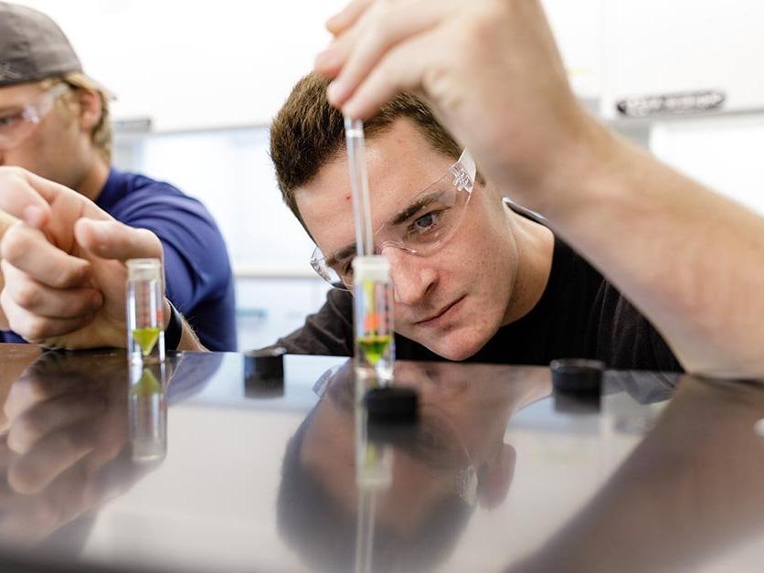 A student measures liquid in a beaker